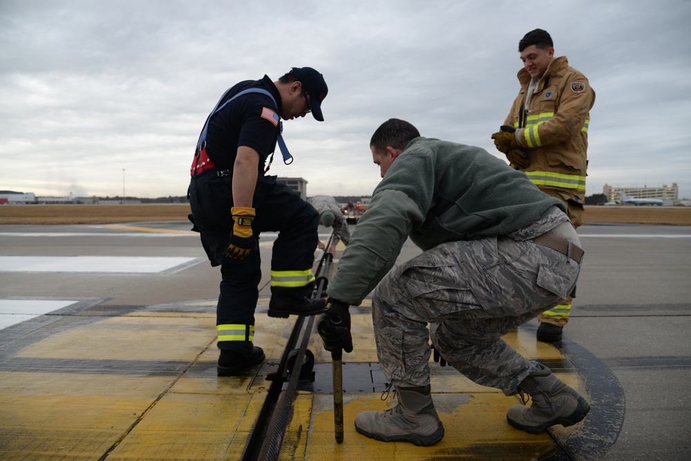 177th Fighter Wing pilots, firefighters, power production and civilian personnel perform active fighter aircraft cable arresting system test