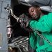 U.S. Sailor ties down an MH-60S Sea Hawk