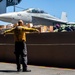 U.S. Sailor signals to lower an aircraft elevator