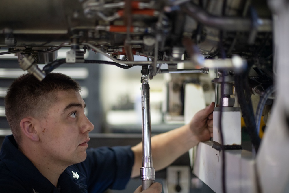 U.S. Sailor torques a jet engine