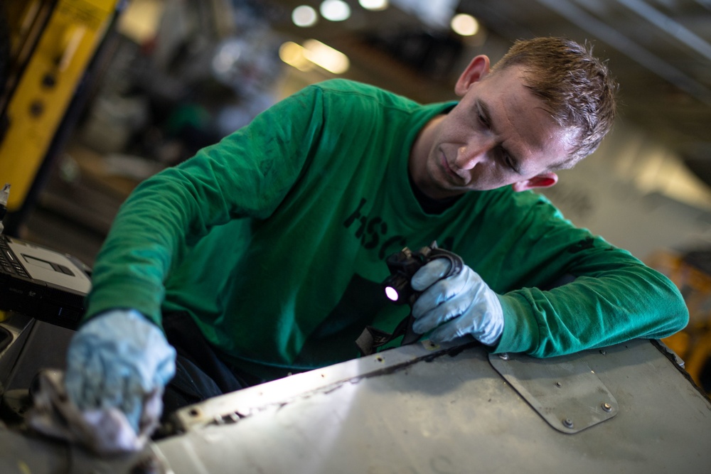 U.S. Sailor conducts a corrosion prevention treatment