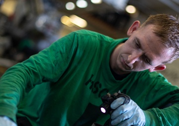 U.S. Sailor conducts a corrosion prevention treatment