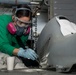 U.S. Sailor paints a cowling for an MH-60S Sea Hawk