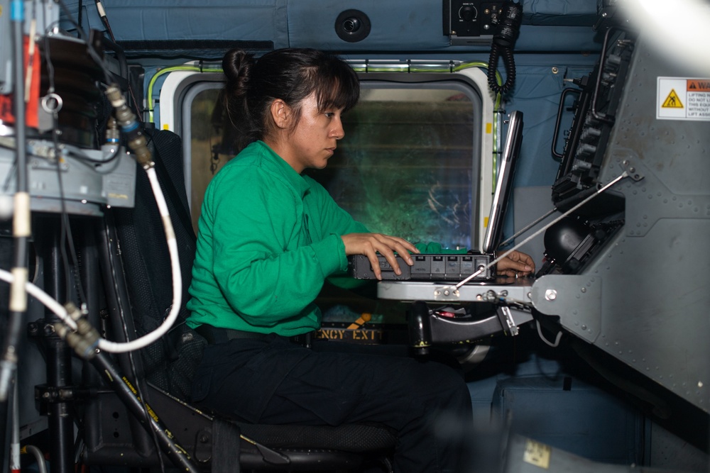 U.S. Sailor conducts a paid-out cable length test on an MH-60R Sea Hawk