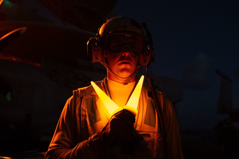 U.S. Sailor signals aircraft