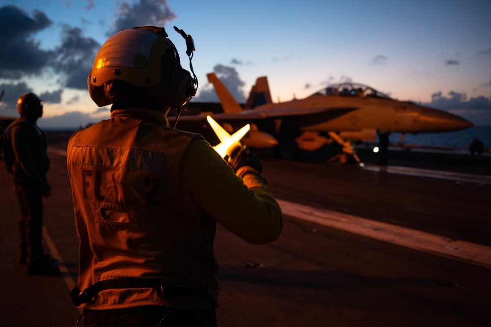 U.S. Sailor directs an EA-18G Growler