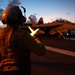 U.S. Sailor directs an EA-18G Growler