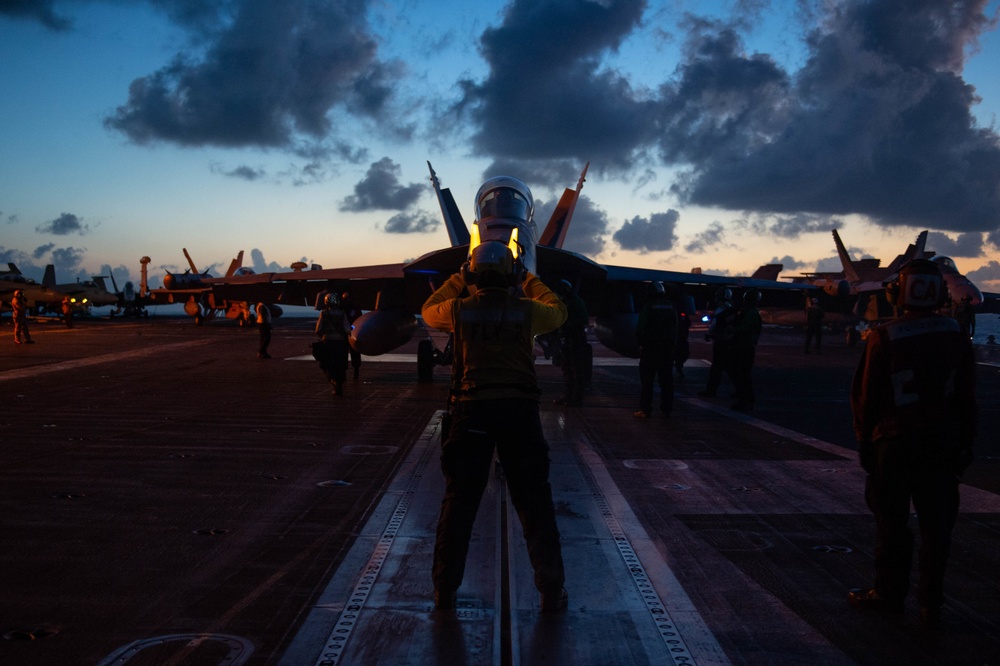 U.S. Sailor directs an EA-18G Growler