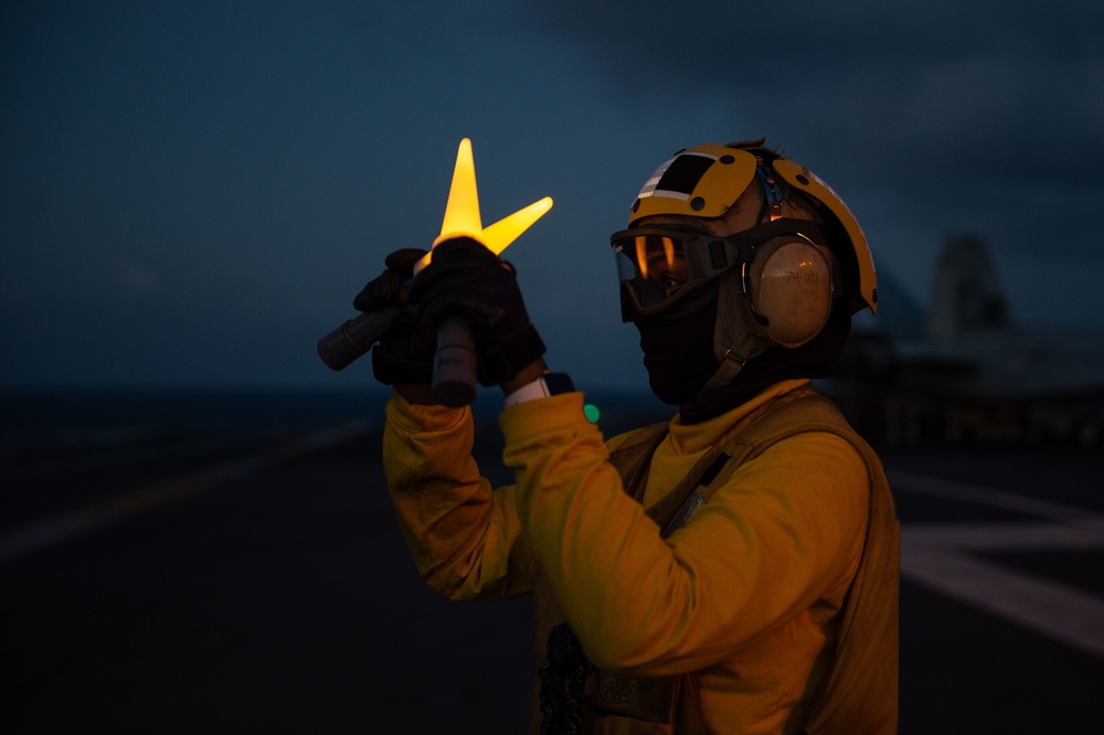 U.S. Sailor signals aircraft