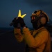 U.S. Sailor signals aircraft