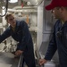 U.S. Navy Boatswain’s Mate Chief Christopher Haws explains ways to plug a simulated hole in the bulk head