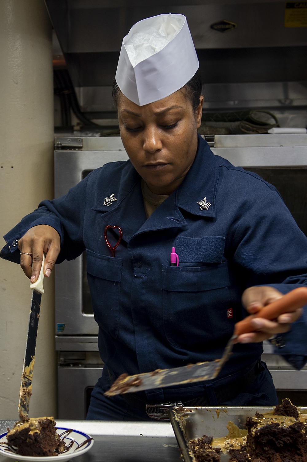 U.S. Navy Ship’s Serviceman 1st Class Annalier Mitchell, from Trinidad, plates a desert