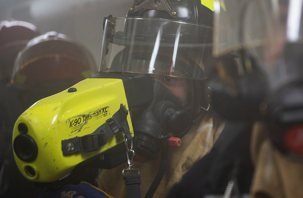 U.S. Navy Damage Controlman 3rd Class James Fry, from Corona, Cali., uses a Naval Firefighting Thermal Imager