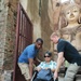 Soldiers help woman enter temple during CG 19