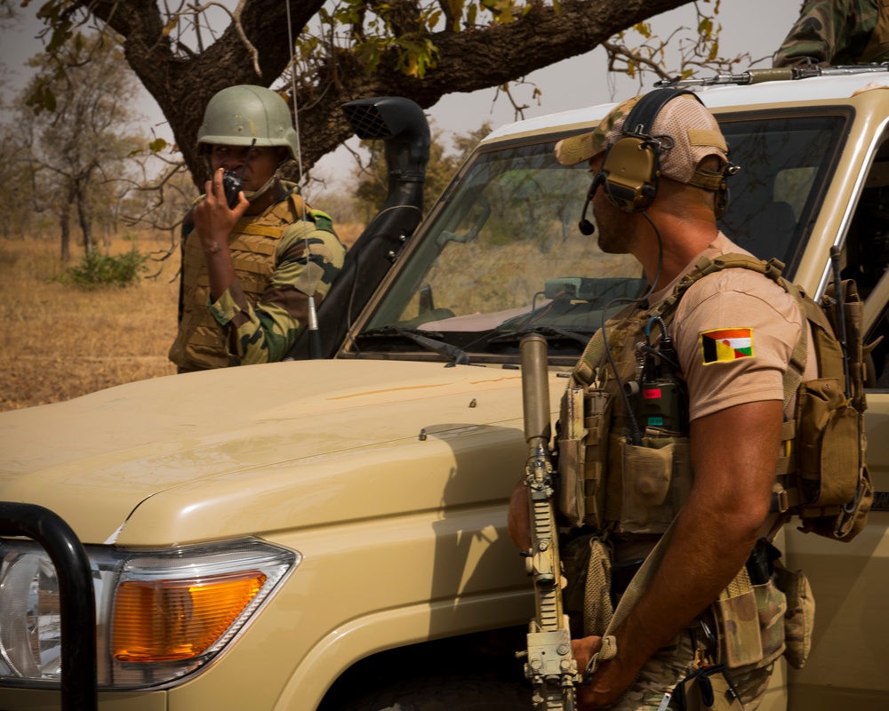 Belgian special operations soldier listens to the Nigerien ground commander give radio orders