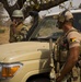 Belgian special operations soldier listens to the Nigerien ground commander give radio orders