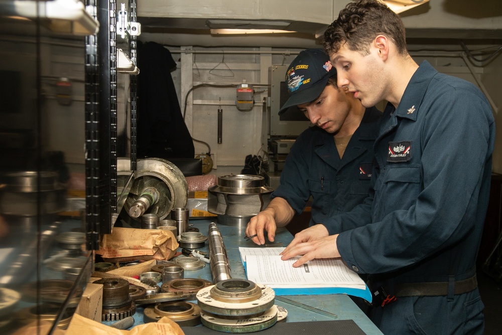 U.S. Sailors assemble a saltwater pump