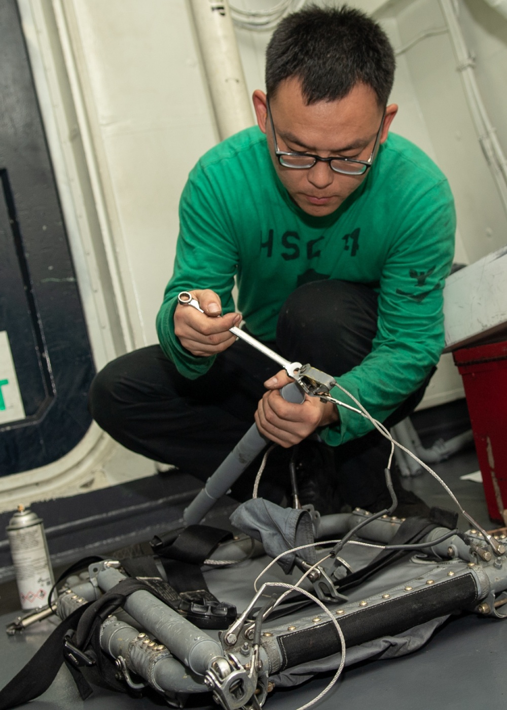 U.S. Sailor conducts maintenance