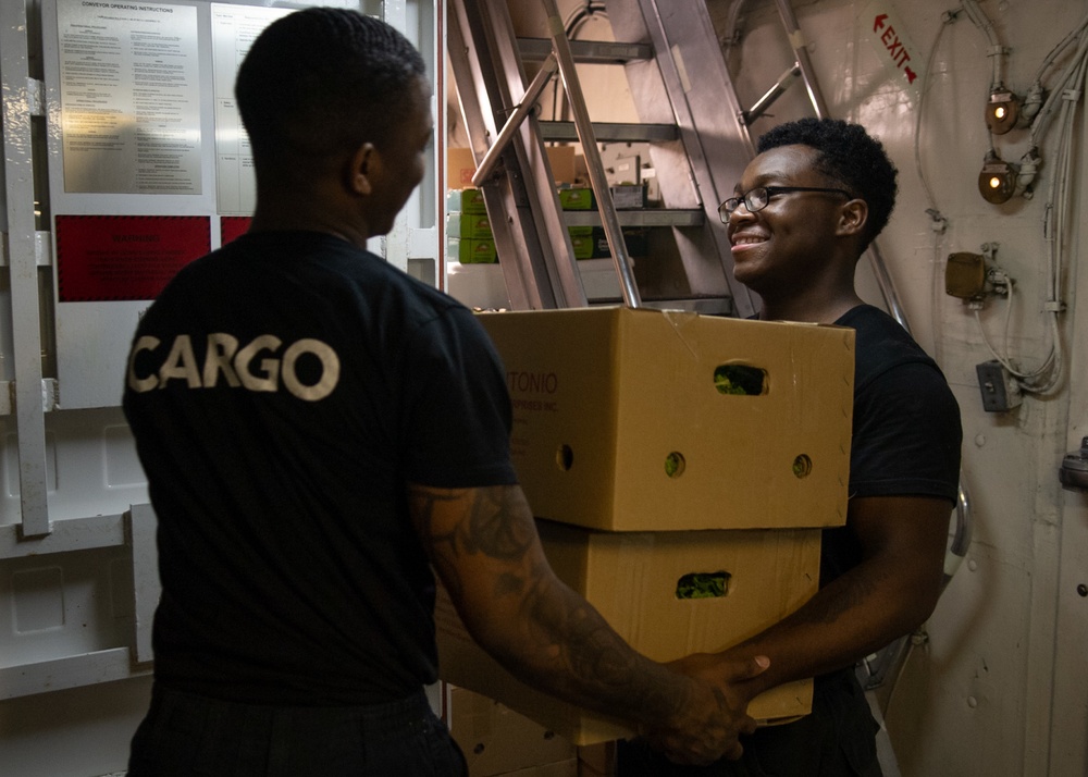 U.S. Sailors haul boxes