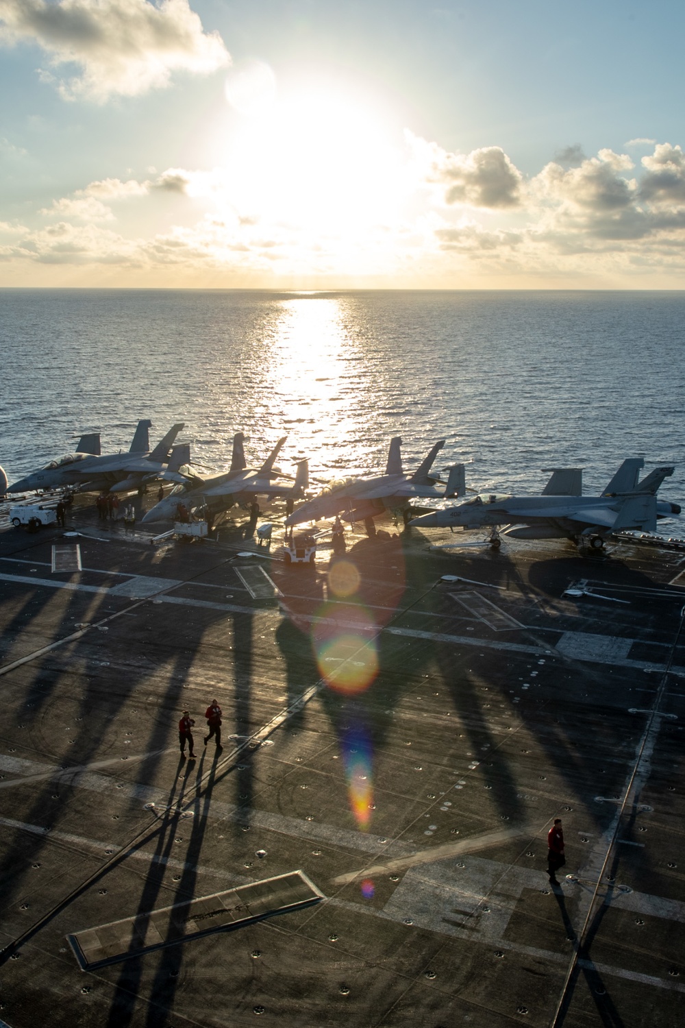 U.S. Sailors transit the flight deck