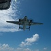 E-2C Hawkeye flies over the aircraft carrier USS John C. Stennis (CVN 74)