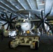 U.S. Sailors transit around an E-2C Hawkeye