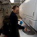 U.S. Sailor prepares a load of laundry