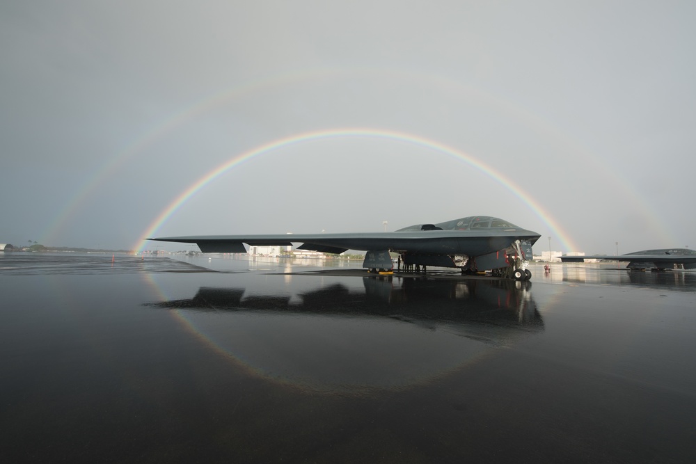 B-2 parked on flightline under a double rainbow in Hawaii