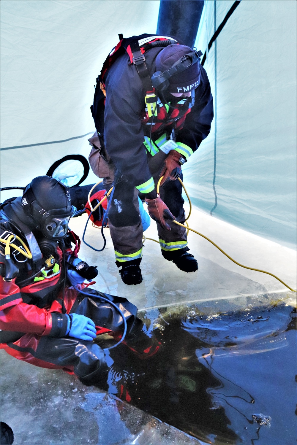 Fort McCoy firefighters practice diving under ice for rescue operations