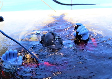Fort McCoy firefighters practice diving under ice for rescue operations
