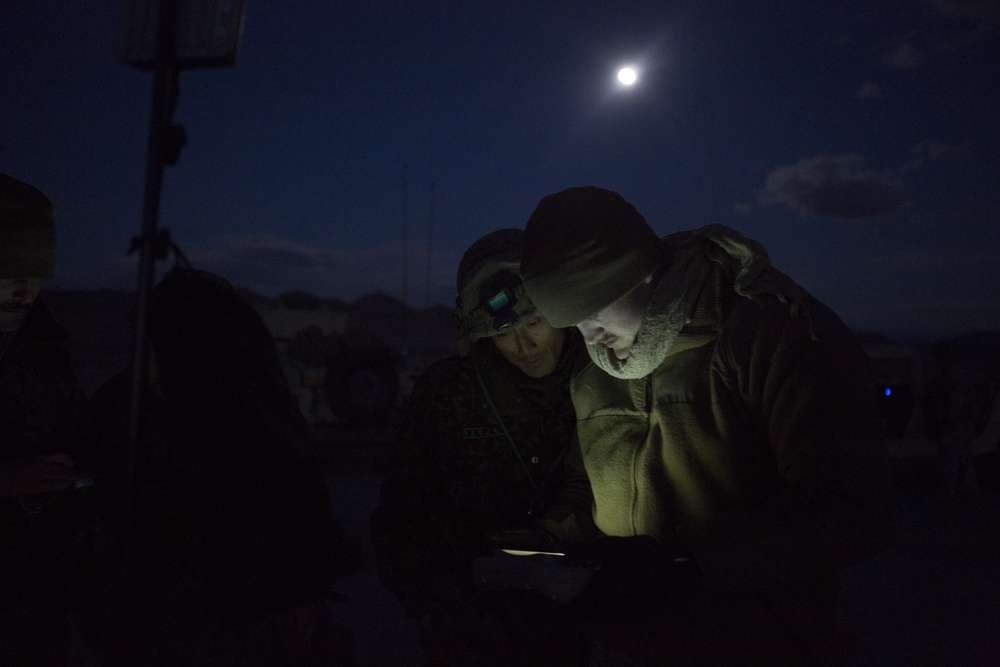 Marines display the RQ-20B Puma to Japanese Ground Self Defense Force Soldiers