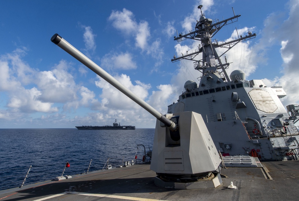 The guided-missile destroyer USS Preble (DDG 88) changes course after steaming beside the aircraft carrier USS John C. Stennis (CVN 74) during flight operations in the Pacific Ocean, Feb. 19, 2019.