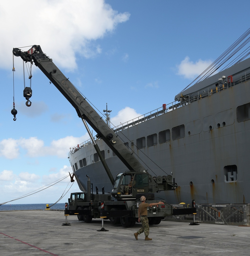 Naval Mobile Construction Battalion (NMCB) 133 det. Guam’s crane crew conduct a turnover crane lift