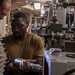 U.S. Navy Engineman 1st Class Blake Petenbrink, from St. Marys, Ga., and Machinist’s Mate 3rd Class Christopher Johnson, from Mt. Vernon, N.Y., inspect a piston prior to installing it in a drive end assembly of a high-pressure pump aboard the Arleigh Bur