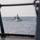 A naval warship with hull number F946 is photographed from the deck of another vessel at sea. The ship appears to be a frigate or corvette flying what appears to be an Egyptian naval ensign, photographed through the railings and structural elements of the observing vessel. The sea conditions are calm with an overcast sky.