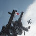 An E-2C Hawkeye flies over the aircraft carrier USS John C. Stennis (CVN 74)