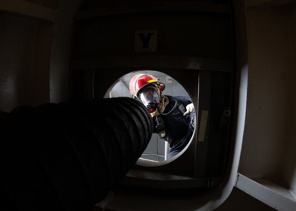 U.S. Sailor  assembles a trunk during a simulated fire