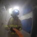 U.S. Sailor transits a berthing during a simulated fire