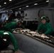 U.S. Sailors inspect an F/A-18E Super Hornet