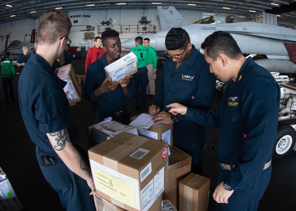 U.S. Sailors sort supplies