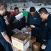 U.S. Sailors sort supplies