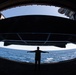 U.S. Sailor signals to lower an aircraft elevator