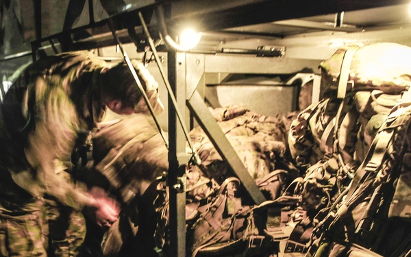 Paratrooper loads gear