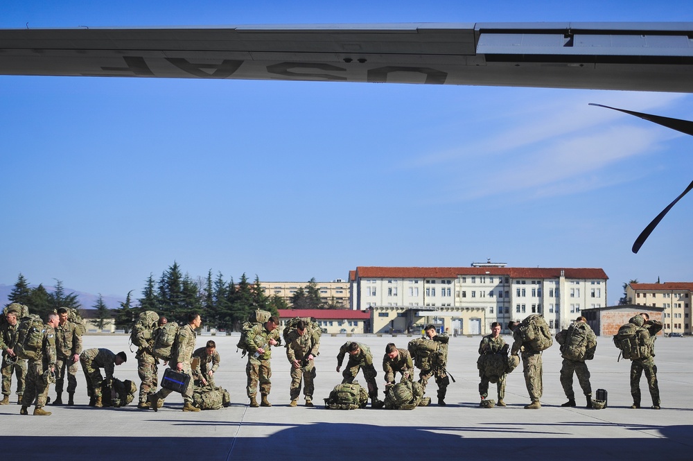 Paratroopers prepare to load C-130