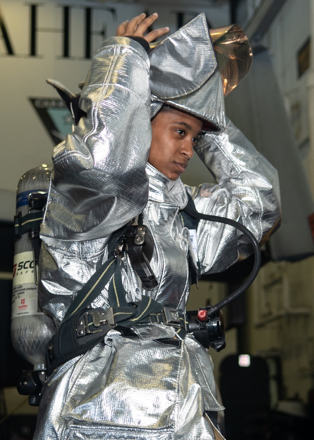 U.S. Sailor dons a proximity suit