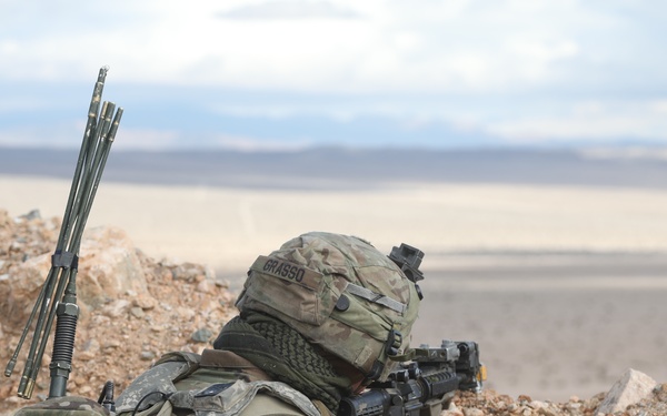 Soldier Aims at Targets Over Hill