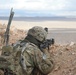 Soldier Aims at Targets Over Hill