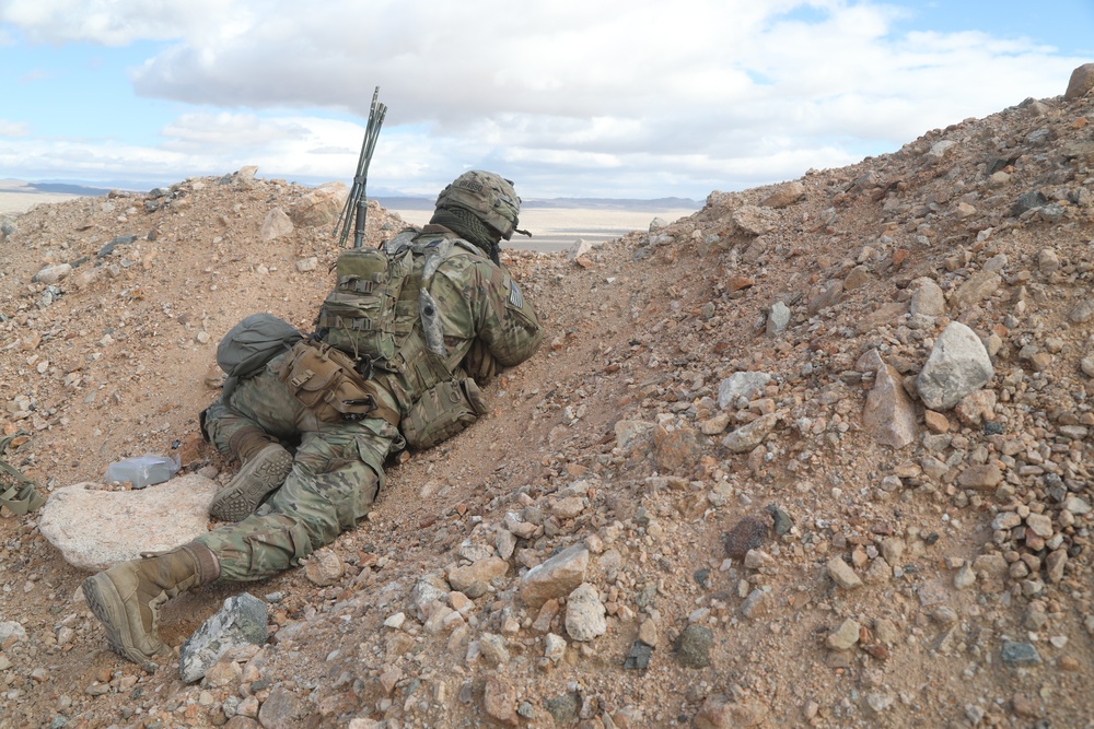 U.S. Army Soldier Climbs Hill to Look for Simulated Enemies