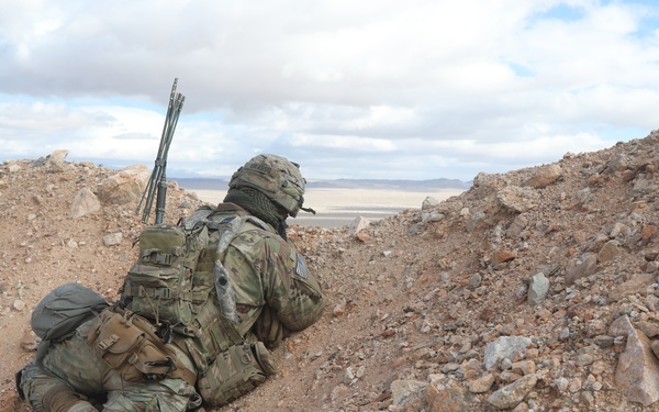 U.S. Army Soldier Climbs Hill to Look for Simulated Enemies