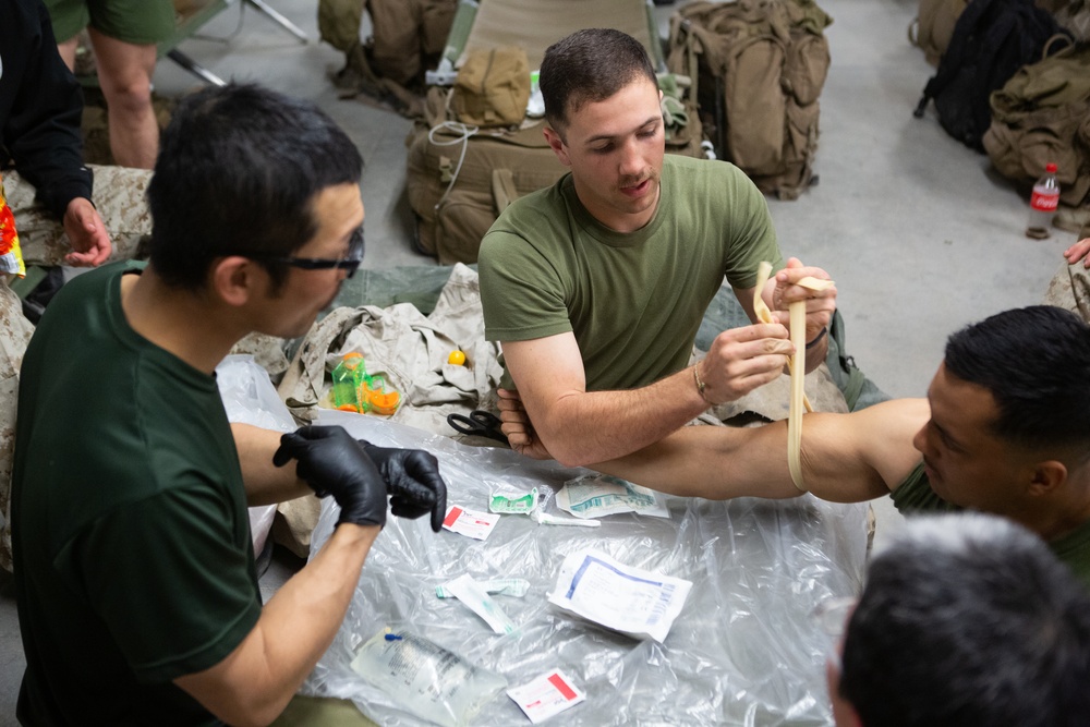 Marines and JGSDF soldiers give each other IVs